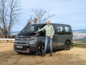 Ein Mann steht neben dem Kia PV5. 
