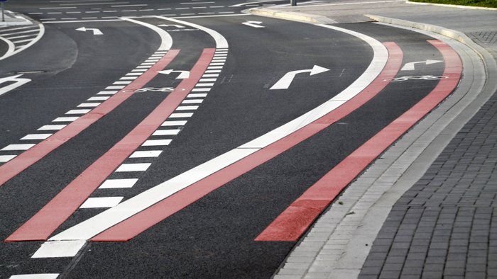 Fahrbahnmarkierung auf einer Straße in unterschiedlichen Farben.