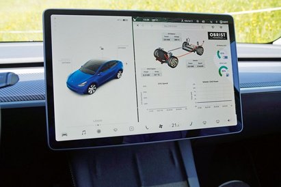 Bildschirm eines Teslas im Auto mit Informationen zum Auto.