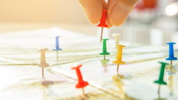 Landkarte mit verschiedenfarbigen Pins.