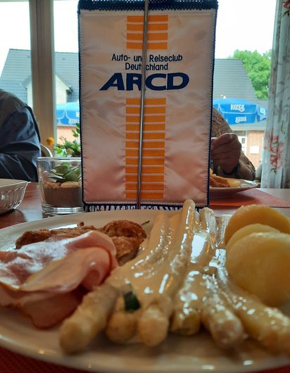 Ein Teller mit Spargel vor dem Fahne des ARCD