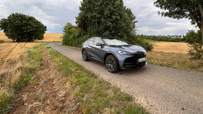 Cupra Tavascan steht auf einem Weg. 