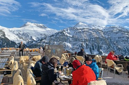 Außengastronomie mit Gästen in einem Bergrestaurant im Skigebiet Lech-Zürs.