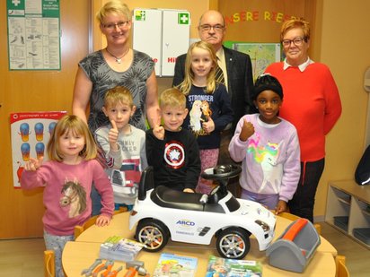 Kindergartenkinder mit ARCD Rutschauto.