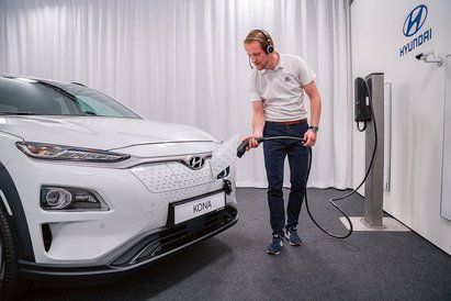 Verkaufsberater lädt Auto im Showroom.