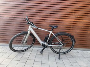 Das E-Bike Cube Editor Hybrid vor einer Wand.