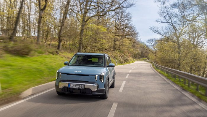 Der Kia EV2 fährt auf der Landstraße. 